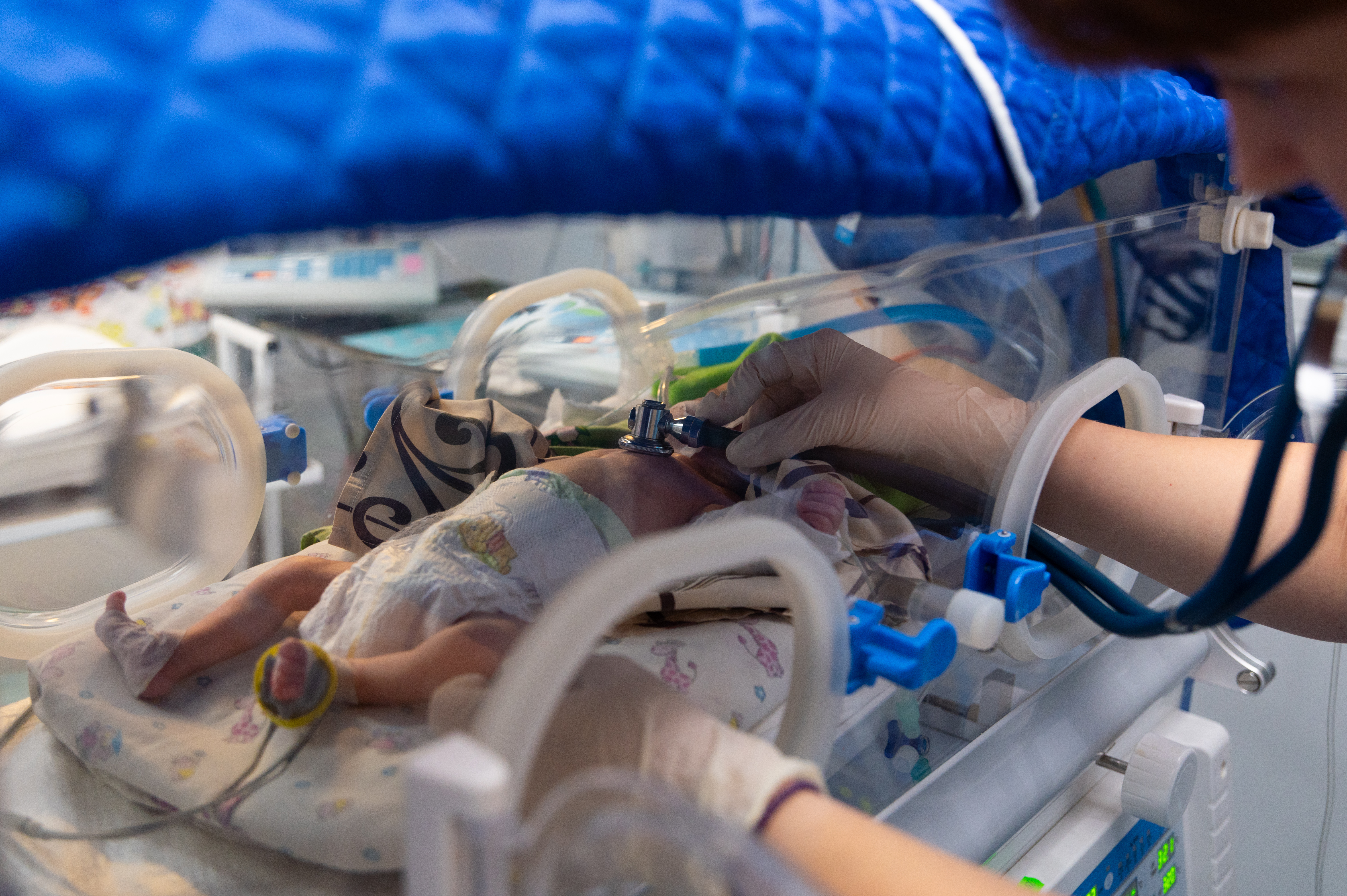 A baby receives care in an incubator