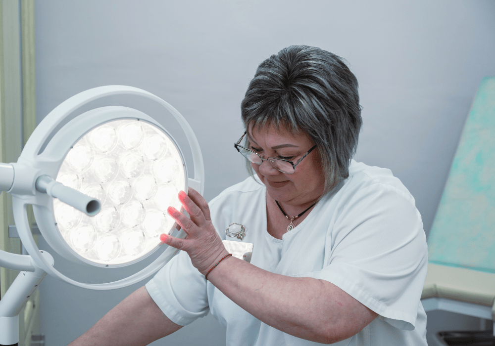 Nurse Inna adjusts a large examination lamp