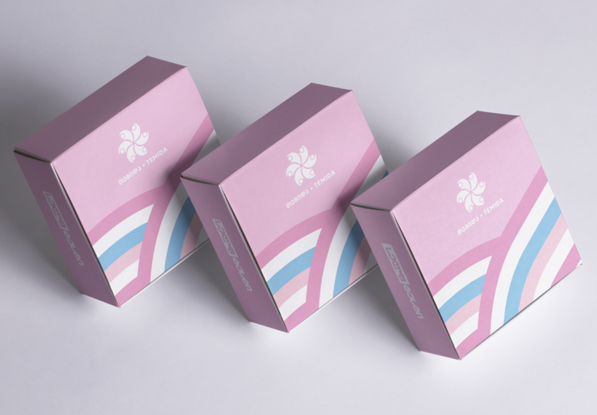 Three HIV prevention kits prepared by TEMIDA - pink boxes with pink, white and blue stripes across the bottom