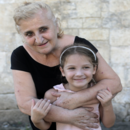 Elderly woman with her granddaughter in a home environment. Photo by Dina Oganova.