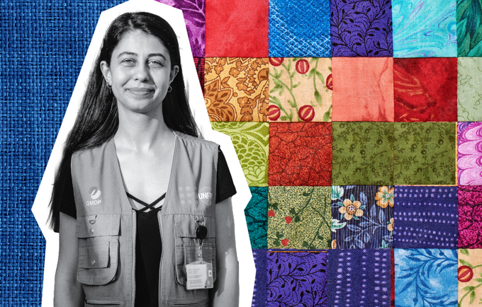 Black and white cutout photo of a young smiling woman in a UNFPA-branded vest. Colorful quilt pattern is placed behind her.