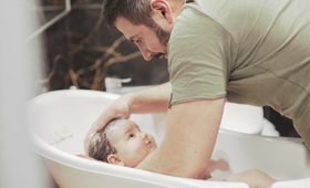 Gabriel Encev bathes his young baby at home in Chisinau, Republic of Moldova.