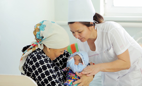 Midwife Venera Jumabayeva assists a new mother