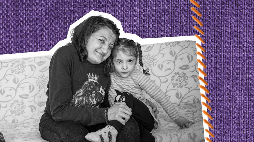  A black and white photo cutout of a woman embracing a young girl on the couch, both looking into the camera.